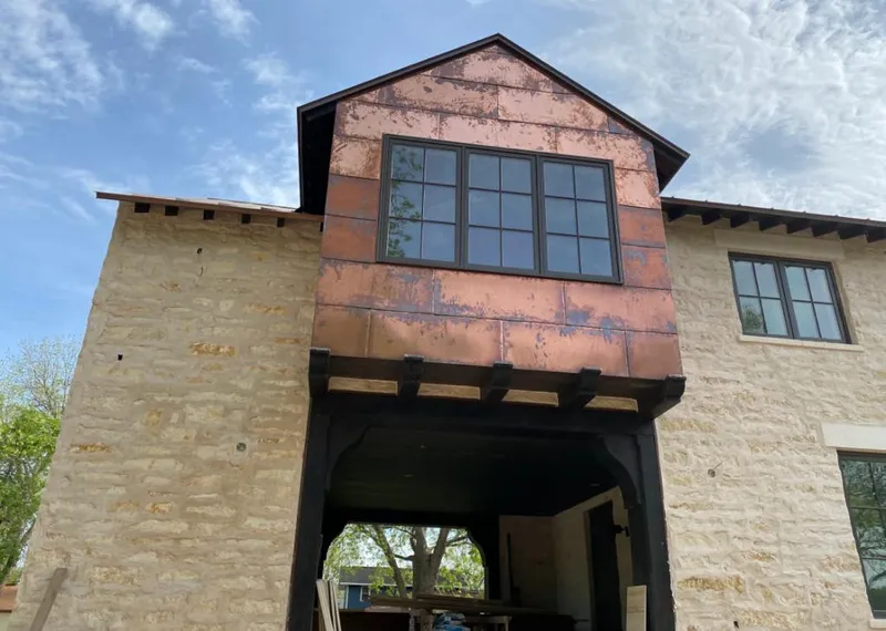 Copper metal panel facade on a stone building for Roof Repair in Bay Harbor Islands