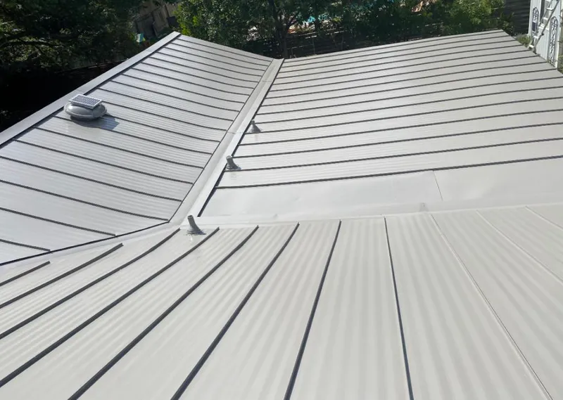 Solar attic fan installed on a metal roof for Roof Ventilation in Bay Harbor Islands